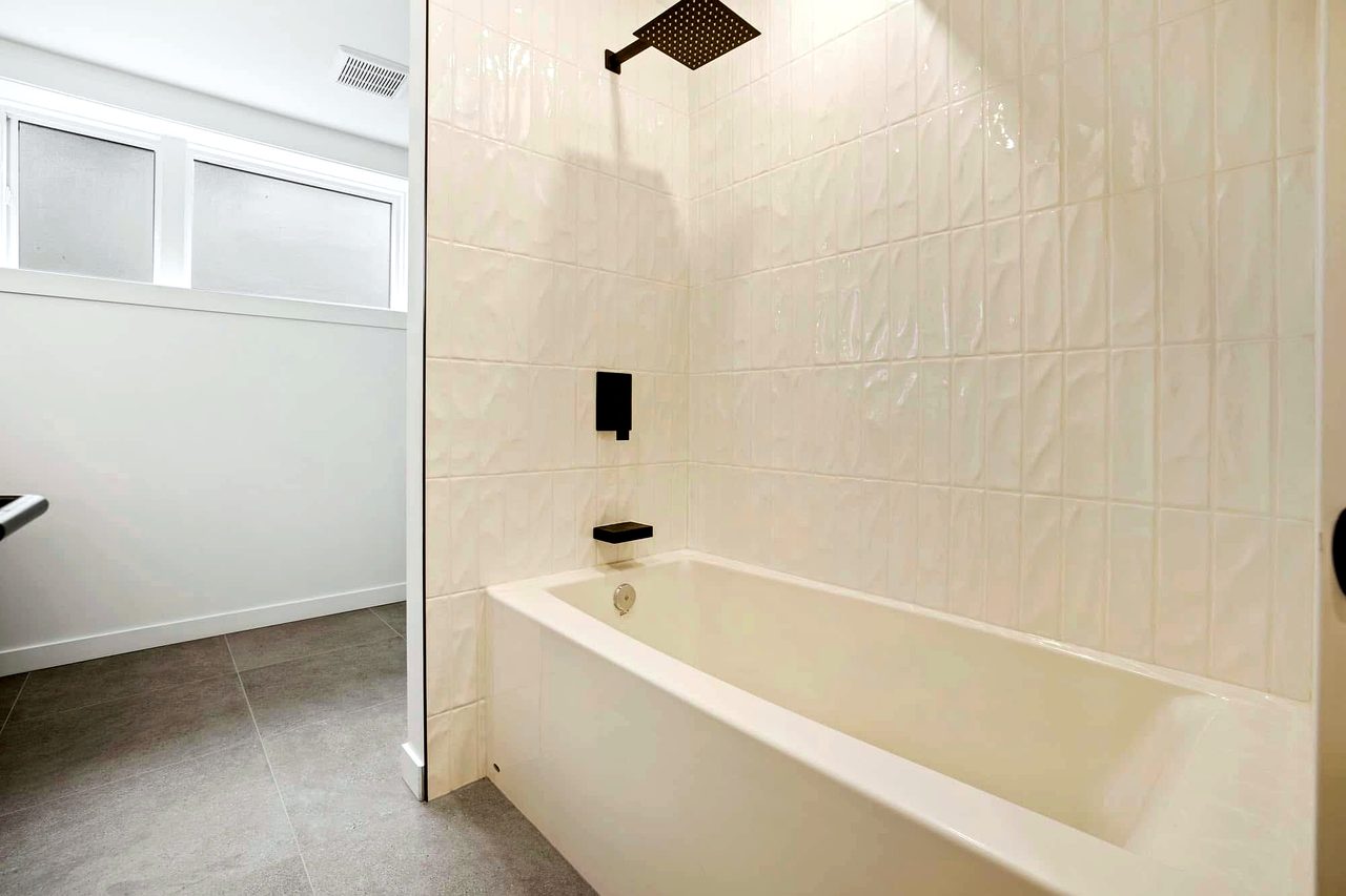 Luxury bathroom renovation with a floating wood vanity and dual vessel sinks